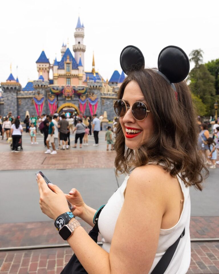 Kat Ward on the phone at Disneyland, planning a client's Disney vacation